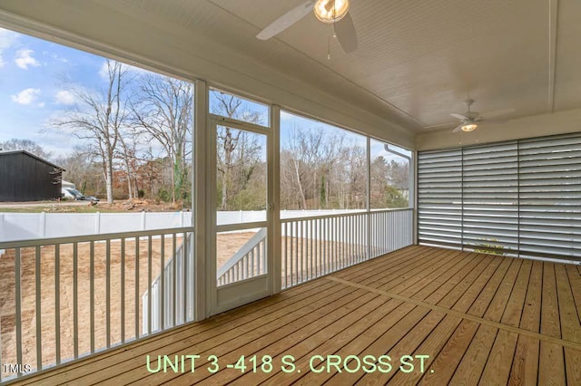 unfurnished sunroom with a ceiling fan