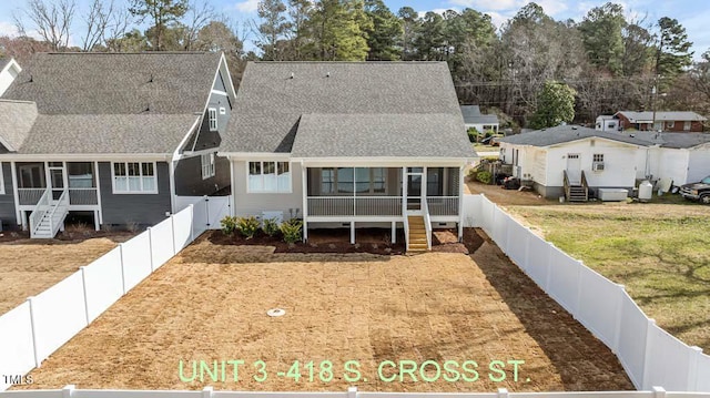 back of house with a sunroom, a fenced backyard, stairs, and a shingled roof