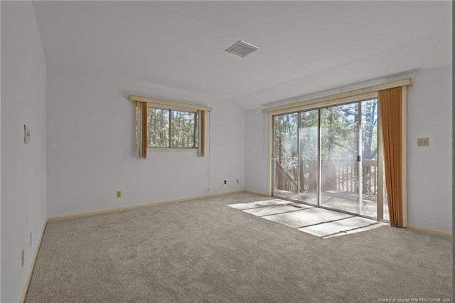 unfurnished room featuring baseboards, visible vents, and carpet floors