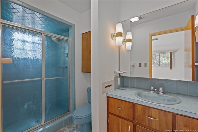 full bath with a shower stall, toilet, and vanity