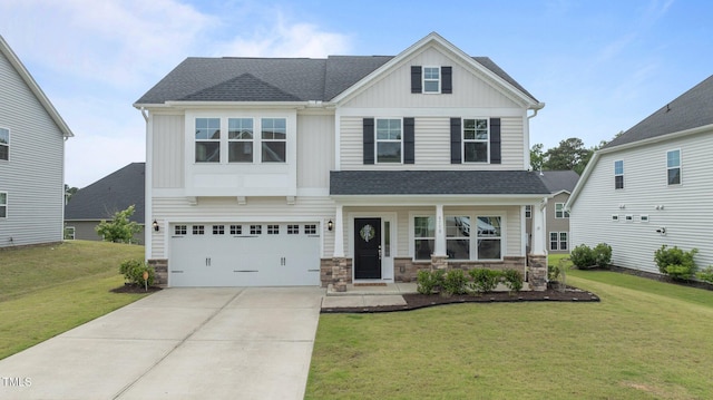 craftsman-style house with a front lawn, concrete driveway, a garage, and stone siding