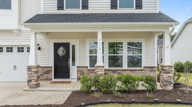 view of exterior entry featuring stone siding, a porch, and a shingled roof