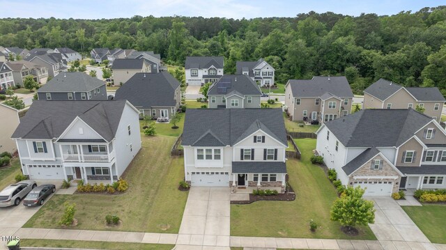 aerial perspective of suburban area with a heavily wooded area