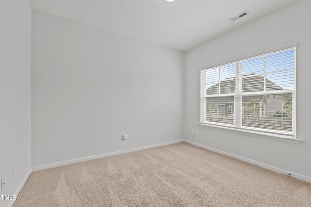 empty room featuring carpet floors and baseboards
