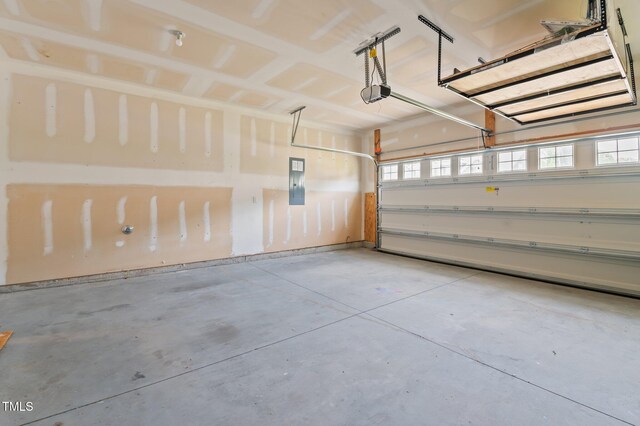 garage featuring a garage door opener and electric panel