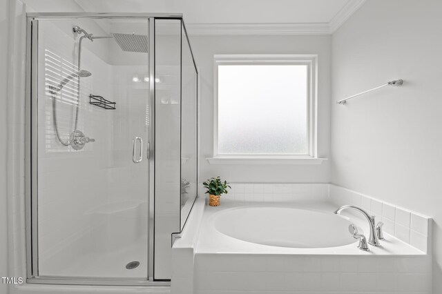 full bathroom featuring a garden tub, a shower stall, and ornamental molding
