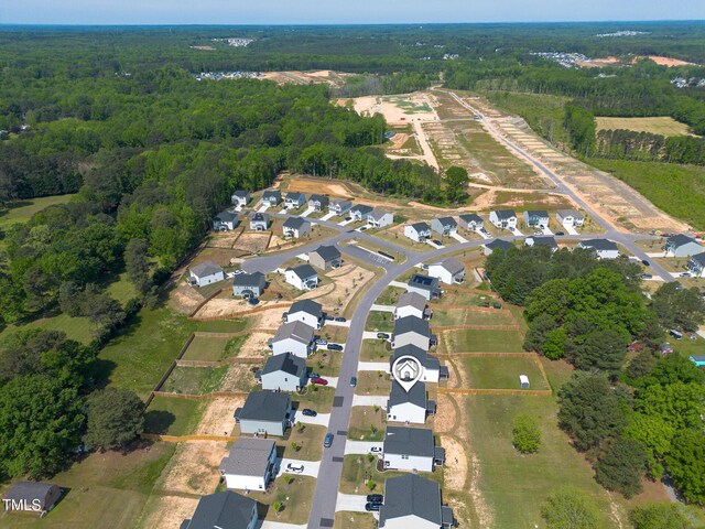 drone / aerial view with a view of trees and a residential view