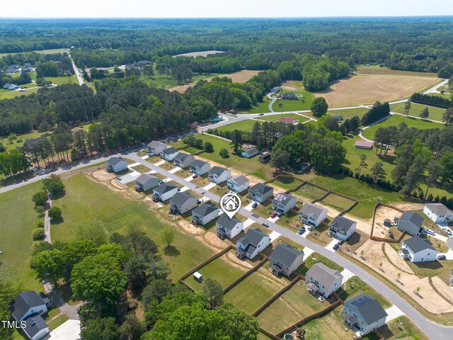 drone / aerial view featuring a view of trees and a residential view