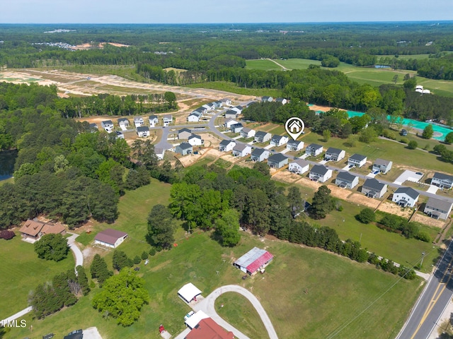 bird's eye view with a wooded view
