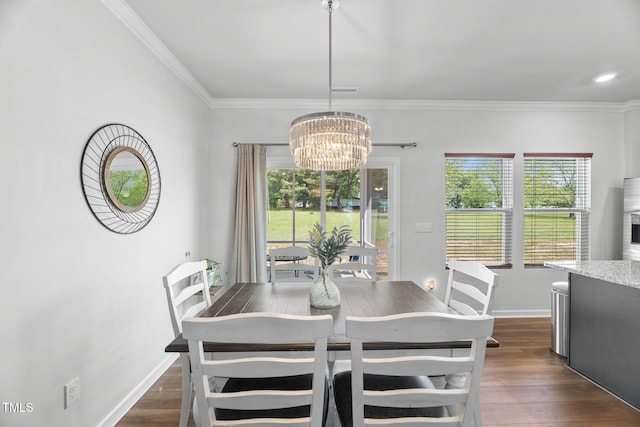 dining room with crown molding, dark wood-style floors, a chandelier, and plenty of natural light