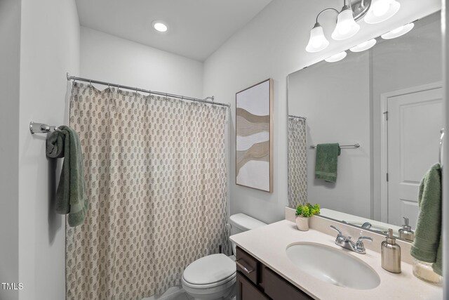 bathroom featuring recessed lighting, a shower with shower curtain, toilet, and vanity