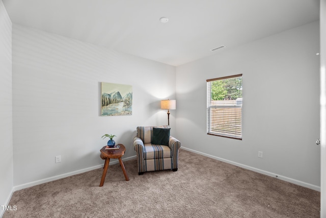 sitting room featuring visible vents, carpet flooring, and baseboards