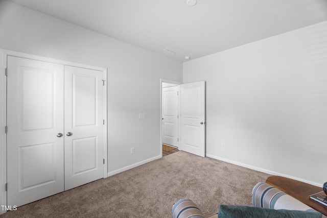 interior space featuring visible vents, carpet floors, and baseboards