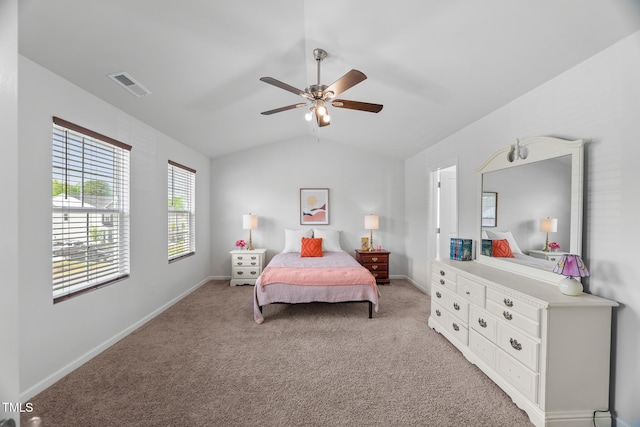 bedroom featuring visible vents, baseboards, vaulted ceiling, and light carpet