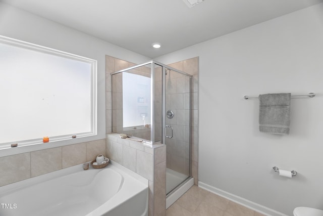 full bath featuring tile patterned floors, baseboards, a shower stall, and a garden tub