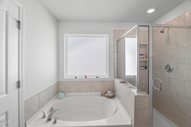 full bathroom with a garden tub, a stall shower, recessed lighting, and a healthy amount of sunlight