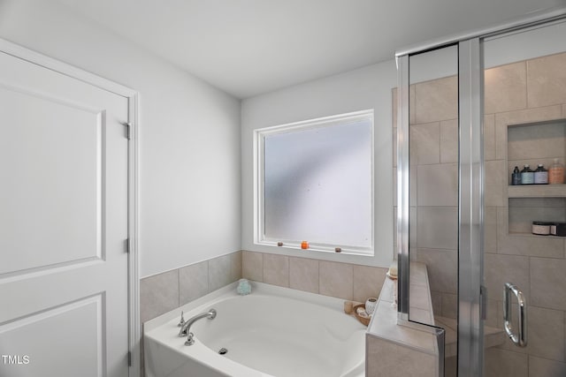 full bathroom featuring a garden tub and a stall shower