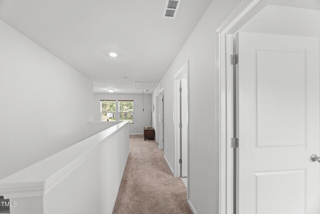 corridor featuring recessed lighting, attic access, light carpet, baseboards, and visible vents