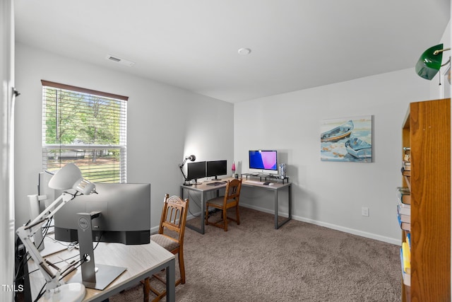 office space featuring visible vents, carpet floors, and baseboards
