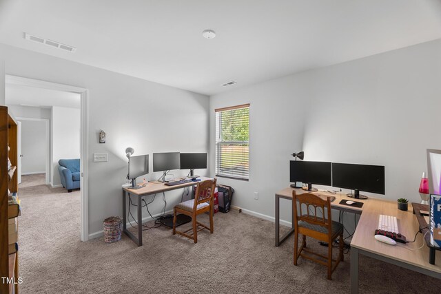 carpeted office space with visible vents and baseboards