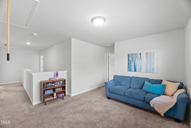 living area with attic access, carpet flooring, and baseboards