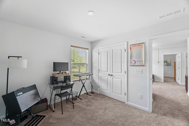 office area featuring visible vents, carpet flooring, and baseboards