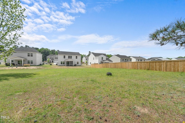 view of yard featuring fence and a residential view