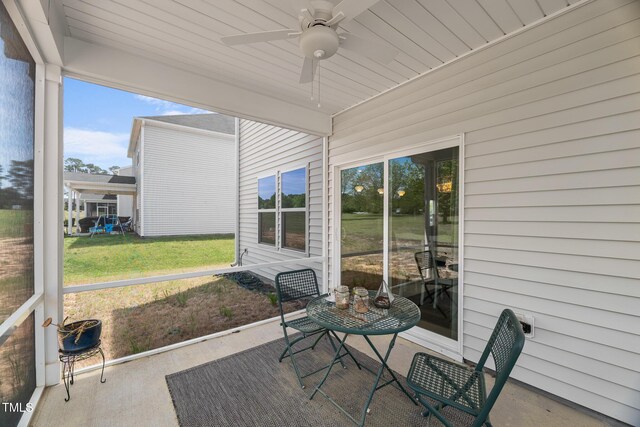 sunroom featuring ceiling fan