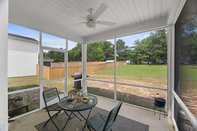sunroom featuring a wealth of natural light and a ceiling fan