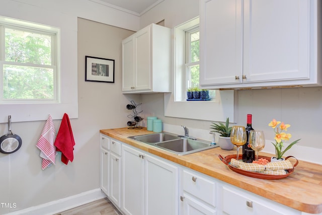 919 Orient St, Durham, NC 27701 - kitchen featuring wood counters, a healthy amount of sunlight, and a sink