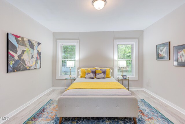 919 Orient St, Durham, NC 27701 - bedroom with light wood-style flooring, baseboards, and multiple windows