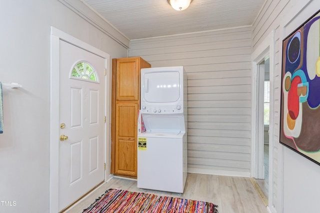 919 Orient St, Durham, NC 27701 - foyer entrance featuring stacked washer and dryer, wooden walls, and light wood-style flooring