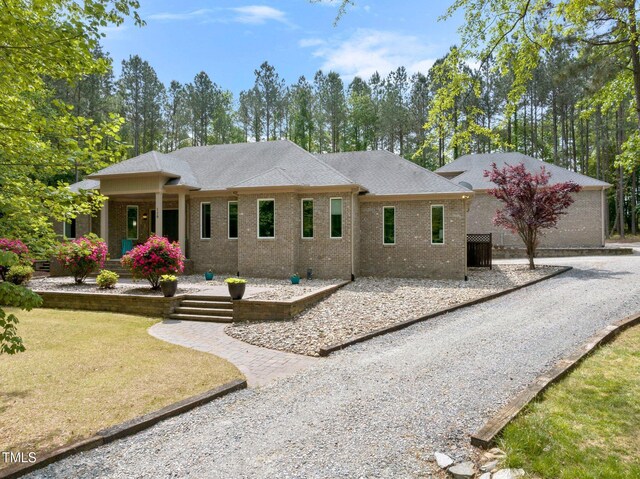 120 Wood Lake Dr, Fuquay Varina, NC 27526 - view of front of house with a garage, brick siding, a porch, and driveway