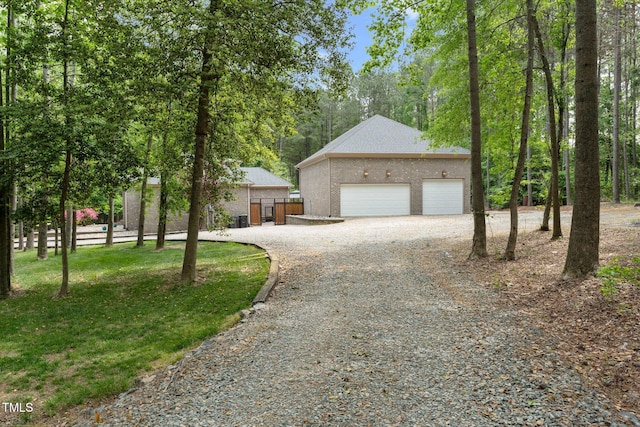 120 Wood Lake Dr, Fuquay Varina, NC 27526 - view of front facade with fence, an outbuilding, a detached garage, and stucco siding