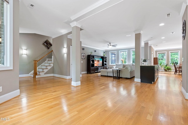 120 Wood Lake Dr, Fuquay Varina, NC 27526 - living area with stairway, ceiling fan, baseboards, ornamental molding, and ornate columns