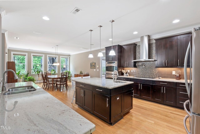 120 Wood Lake Dr, Fuquay Varina, NC 27526 - kitchen with stainless steel appliances, wall chimney exhaust hood, ornamental molding, and a sink