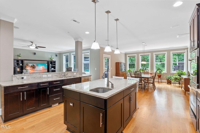 120 Wood Lake Dr, Fuquay Varina, NC 27526 - kitchen featuring light wood finished floors, visible vents, a sink, pendant lighting, and a kitchen island with sink