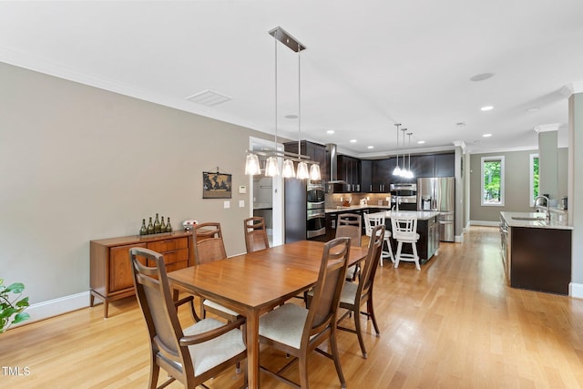 120 Wood Lake Dr, Fuquay Varina, NC 27526 - dining space with baseboards, crown molding, and light wood-type flooring