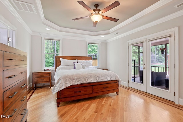 120 Wood Lake Dr, Fuquay Varina, NC 27526 - bedroom featuring access to outside, a tray ceiling, visible vents, and light wood-style flooring