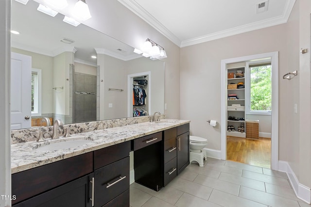 120 Wood Lake Dr, Fuquay Varina, NC 27526 - full bathroom with a sink, tile patterned flooring, a shower stall, a walk in closet, and ornamental molding