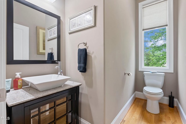 120 Wood Lake Dr, Fuquay Varina, NC 27526 - half bathroom featuring plenty of natural light, baseboards, wood finished floors, and toilet