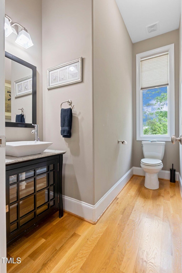 120 Wood Lake Dr, Fuquay Varina, NC 27526 - half bath with visible vents, baseboards, wood finished floors, and toilet