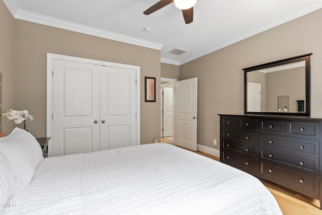 120 Wood Lake Dr, Fuquay Varina, NC 27526 - bedroom featuring light wood-style floors, a closet, baseboards, and ornamental molding