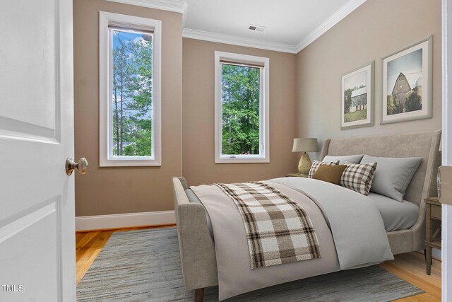 120 Wood Lake Dr, Fuquay Varina, NC 27526 - bedroom with baseboards, visible vents, ornamental molding, and light wood finished floors