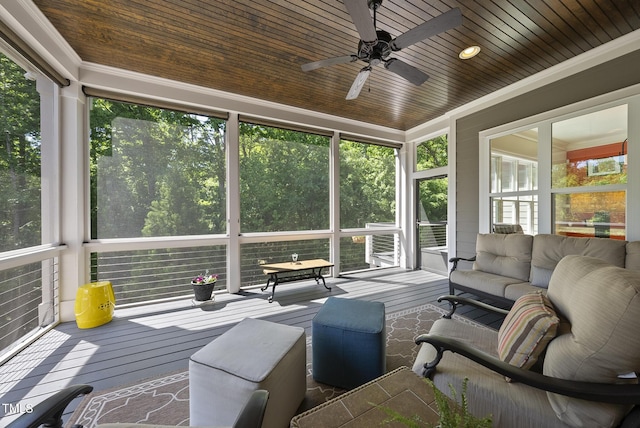 sunroom with ceiling fan and an outdoor living space