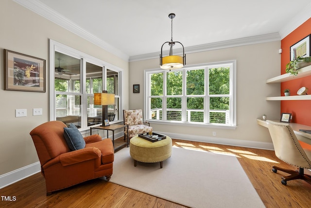 living area with baseboards, ornamental molding, wood finished floors, and a wealth of natural light