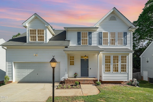 traditional-style home with roof with shingles, an attached garage, concrete driveway, and cooling unit