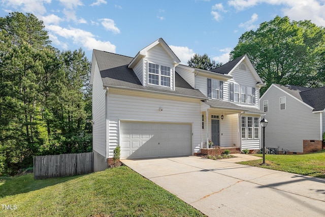 traditional home featuring fence, driveway, and a front yard