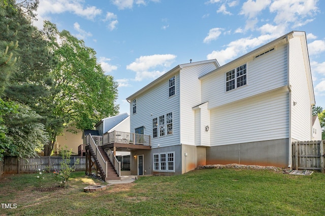 rear view of property with fence, stairs, a yard, and a wooden deck
