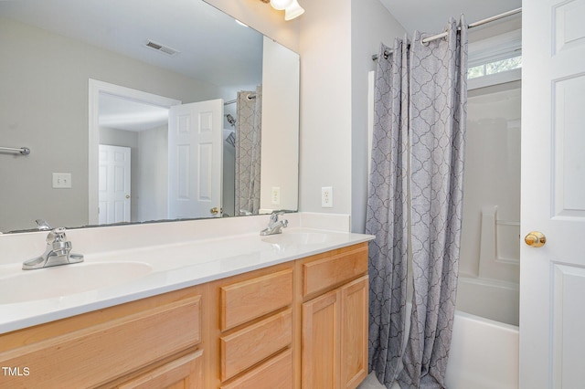 bathroom featuring a sink, shower / tub combo, double vanity, and visible vents